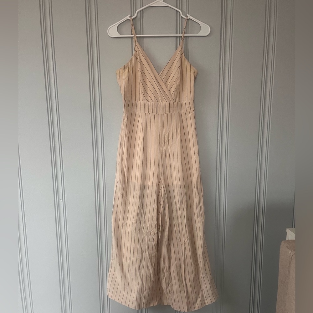 Light pink with black pin stripe jumpsuit with tied bow on the back